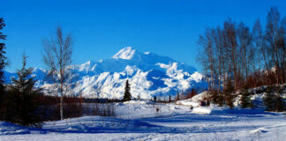 Snowy mountain landscape with clear blue sky