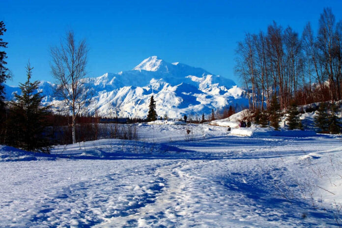 2452760987 Snowy mountain landscape with clear blue sky
