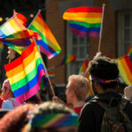 People holding rainbow flags at a pride parade