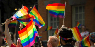 People holding rainbow flags at a pride parade